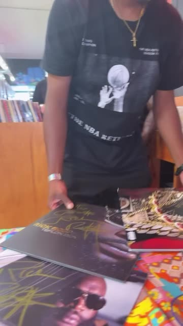 Rick Ross Autographs His Vinyl Collection in Record Store | Video